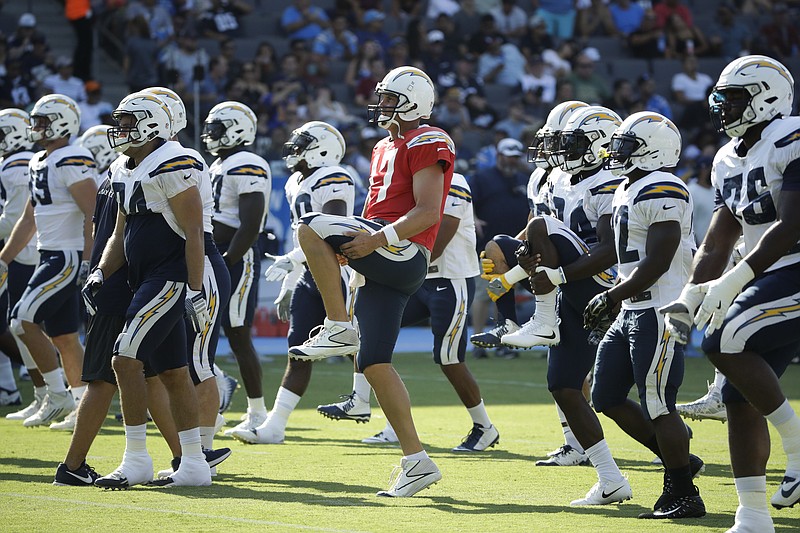 Los Angeles Chargers players warm up before a joint practice with the Los Angeles Rams during an NFL football training camp at StubHub Center, Saturday, Aug. 5, 2017, in Carson, Calif. (AP Photo/Jae C. Hong)