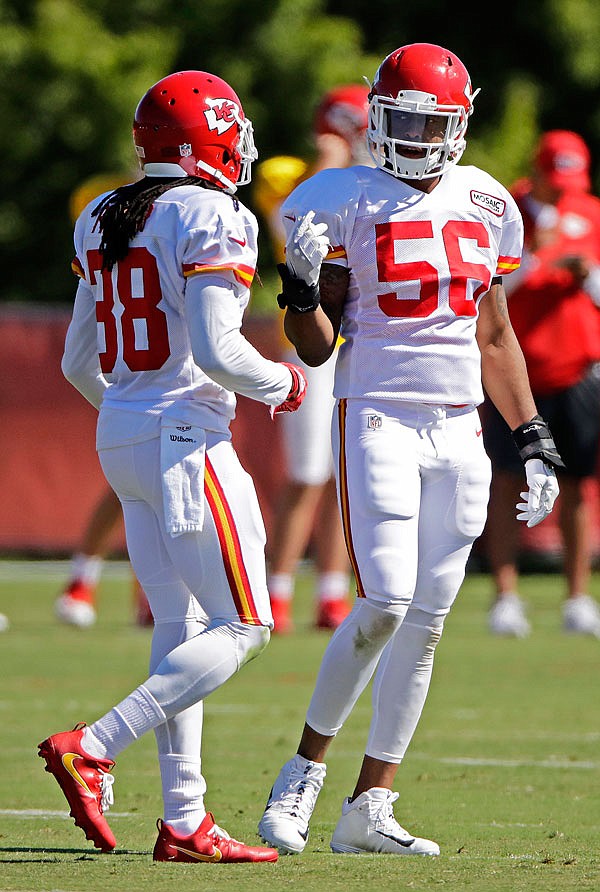Chiefs inside linebacker Derrick Johnson (56) and free safety Ron Parker talk during training camp Friday in St. Joseph.