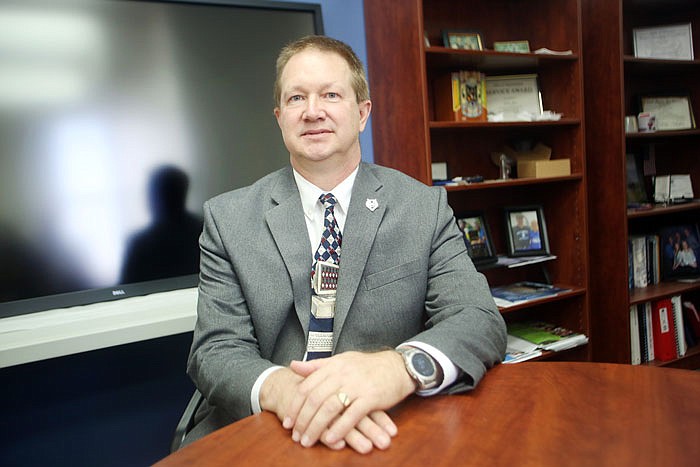 John Bax poses for a portrait in front of the new classroom interactive monitor in his office in Schweich Hall at Lincoln University in Jefferson City.