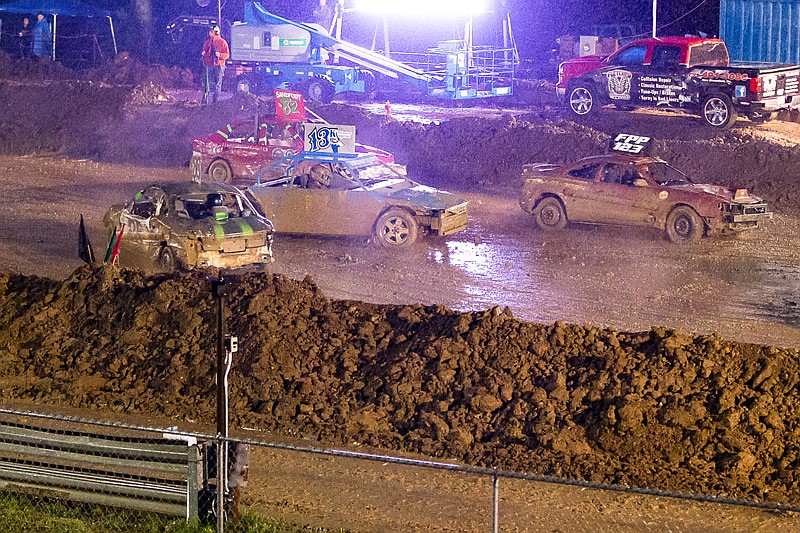 Cars negotiate a slick track in the rain Saturday, Aug. 5, 2017 during the Figure 8 Scramble on the final night of the Jefferson City Jaycees Cole County Fair. The event was cut short due to lightning in the area. The evening's musical acts, Head East Official and Murphy's Ford, were also canceled.