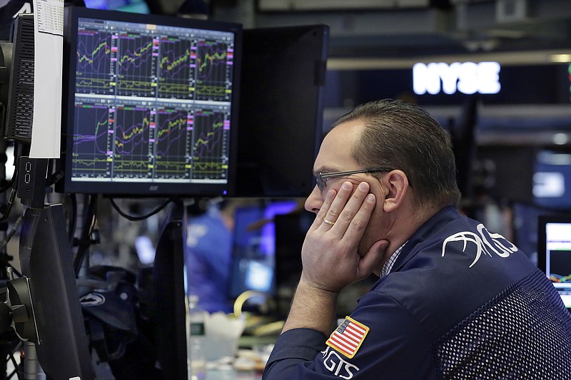 FILE - In this Wednesday, April 26, 2017, file photo, specialist Anthony Matesic works on the floor of the New York Stock Exchange. The year's run to a record for the stock market has been one of the least eventful in decades. But don’t get lulled: Many professional investors expect a bumpier ride ahead. (AP Photo/Richard Drew, File)