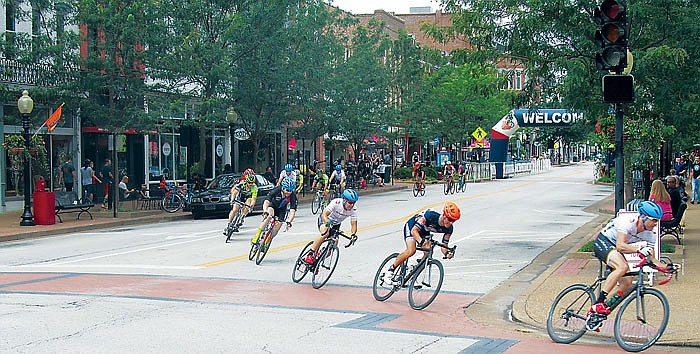 Riders in a master's division turn from High Street to Madison Street during one of about eight races at Sunday's Missouri State Criterium.