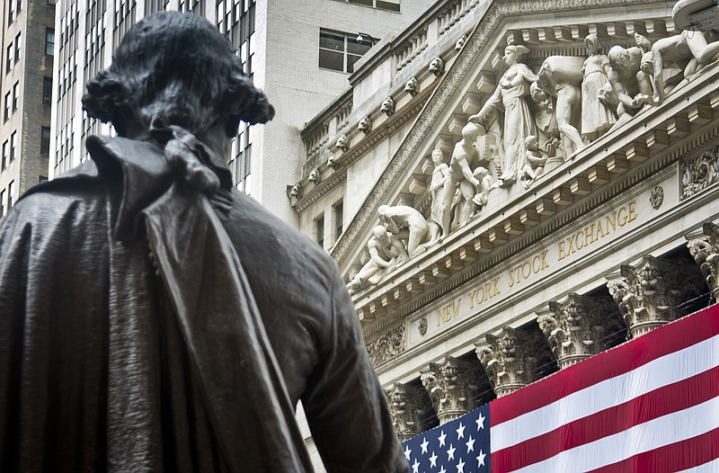 FILE - In this Wednesday, July 8, 2015, file photo, Federal Hall's George Washington statue stands near the flag-covered pillars of the New York Stock Exchange. U.S. stock indexes edged lower in early trading Tuesday, Aug. 8, 2017, pulling back from the market’s most recent record highs. Health care and consumer-focused companies were among the biggest laggards. Energy stocks also fell as crude oil prices headed lower. Banks and utilities had some of the biggest gains. (AP Photo/Bebeto Matthews, File)