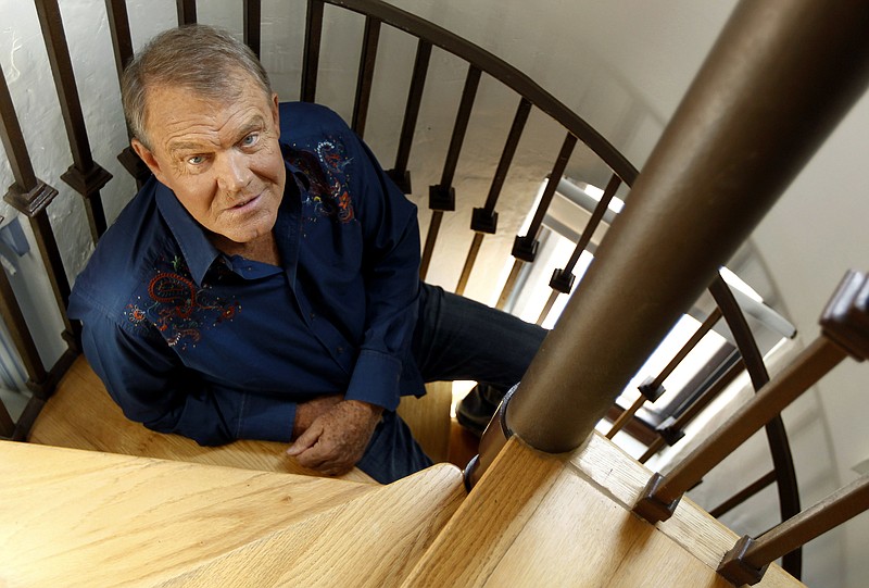 In this July 27, 2011, photo, musician Glen Campbell poses for a portrait in Malibu, Calif. Campbell, the grinning, high-pitched entertainer who had such hits as "Rhinestone Cowboy" and spanned country, pop, television and movies, died Tuesday, Aug. 8, 2017. He was 81. Campbell announced in June 2011 that he had been diagnosed with Alzheimer's disease.