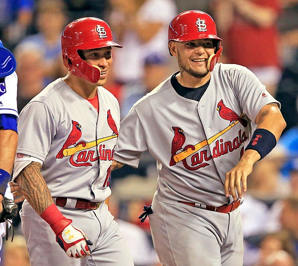 Cardinals second baseman Kolten Wong and catcher Yadier Molina celebrate after Wong's home run during the eighth inning of a Monday night's game in Kansas City.