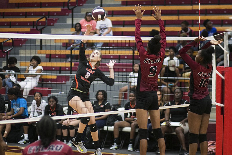 Olivia Lower of Texas High smacks the volleyball over the net to Daycoria Meadows and Tamara Norris of Liberty-Eylau on Tuesday. A scrimmage was held between the two teams at Liberty-Eylau's Rader Dome.