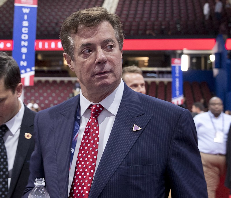 FILE - In this July 18, 2016 file photo, then-Trump campaign chairman Paul Manafort walks around the convention floor before the opening session of the Republican National Convention in Cleveland. A spokesman for President Donald Trump’s former campaign chairman, Paul Manafort, says that FBI agents served a search warrant at one of his homes.  (AP Photo/Carolyn Kaster, File)
