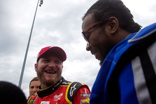 Dale Earnhardt Jr., and Josh Norman of the Redskins share a laugh after driving around the track Tuesday in Richmond, Va.