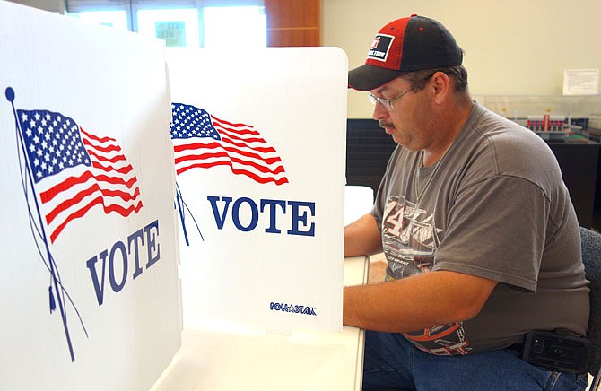 Chris Cheney votes during the August 2017 election.