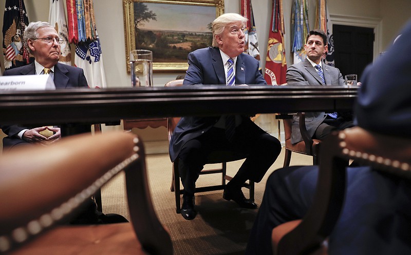 FILE - In this June 6, 2017 file photo, President Donald Trump, flanked by Senate Majority Leader Mitch McConnell of Ky., left, and House Speaker Paul Ryan of Wis., speaks in the Roosevelt Room of the White House in Washington. President Donald Trump resumed his taunts of his party's Senate leader, expressing disbelief that McConnell couldn't persuade a Republican majority to pass a health care bill.  (AP Photo/Pablo Martinez Monsivais, File)