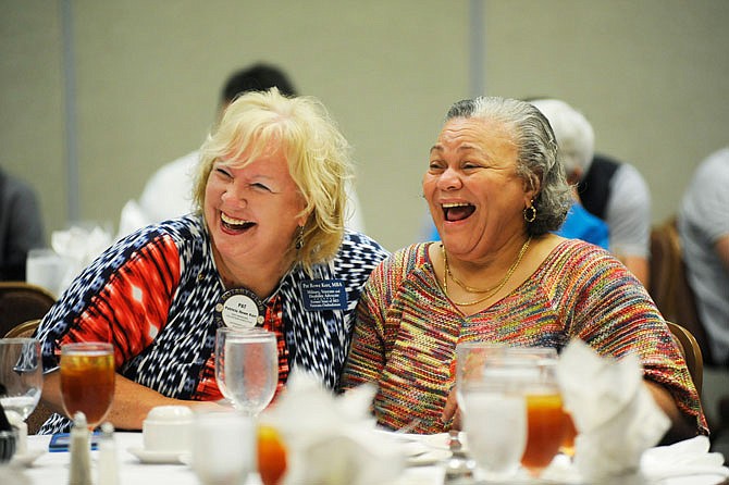 Pat Rowe Kerr and Saundra Allen, mother of Rhonda Allen, laugh during Rhonda's speech Wednesday at the Rotary luncheon to welcome new teachers at Capitol Plaza Hotel.