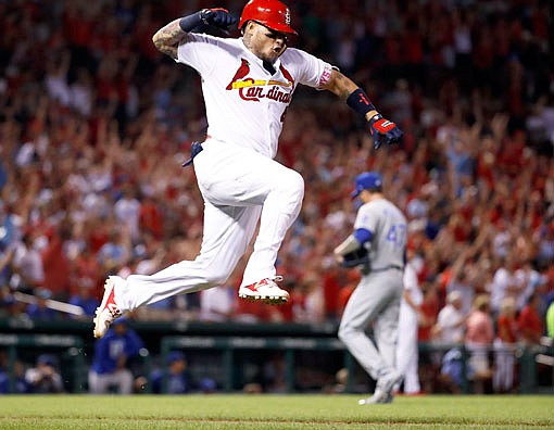 Yadier Molina of the Cardinals celebrates after hitting a grand slam off Royals relief pitcher Peter Moylan during the sixth inning of Wednesday night's game at Busch Stadium.