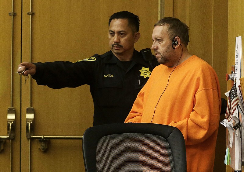 Andrew Warren, right, enters a courtroom for an extradition hearing at the Hall of Justice in San Francisco, Friday, Aug. 11, 2017. Warren, an Oxford University financial officer accused in the fatal stabbing of a Chicago man, has agreed to return to Illinois to face charges. (AP Photo/Jeff Chiu)