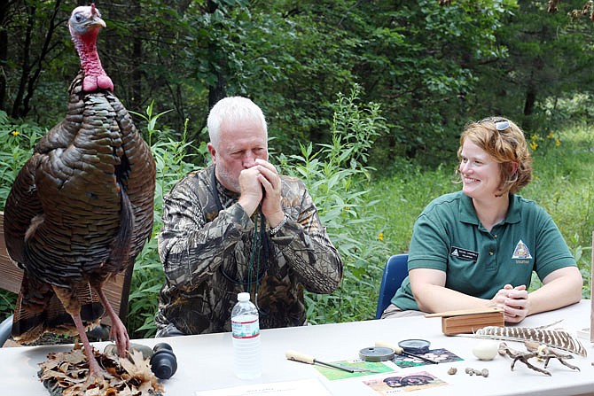 Bill Kuensting, left, and Rachel Campbell demonstrate turkey calls Thursday at Runge Conservation Nature Center. The center held an open house celebrating 80 years of the conservation department's work. Attendees were encouraged to give feedback on improvements they would like to see in conservation efforts.