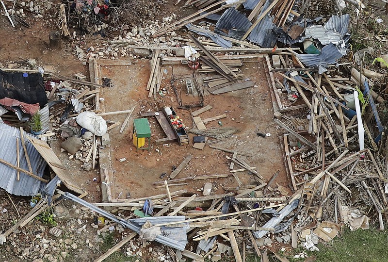 In this Oct. 14, 20-16 file photo, the remains of a destroyed home lay in southwestern Haitia week and a half after Hurricane Matthew devastated the region. A new U.S. report says last year's weather was far more extreme or record breaking than anything approaching normal.
