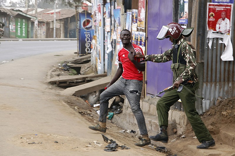 A supporter of opposition leader Raila Odinga is arrested by security forces in the Kibera slum of Nairobi, Kenya, Saturday Aug. 12, 2017. Violent demonstrations have erupted in some areas after President Uhuru Kenyatta was declared victorious of the presidential election (AP Photo/Khalil Senosi)
