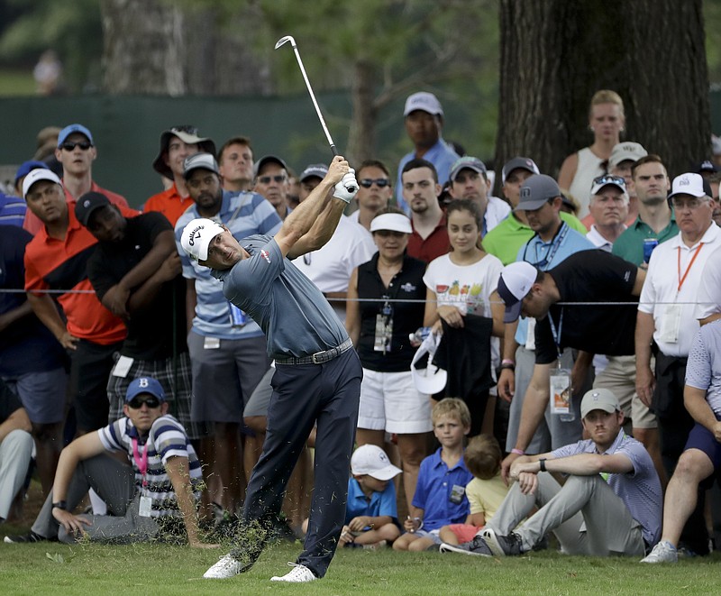 Kevin Kisner hits from the rough on the third hole during the third round of the PGA Championship golf tournament at the Quail Hollow Club Saturday, Aug. 12, 2017, in Charlotte, N.C. (AP Photo/Chris O'Meara)