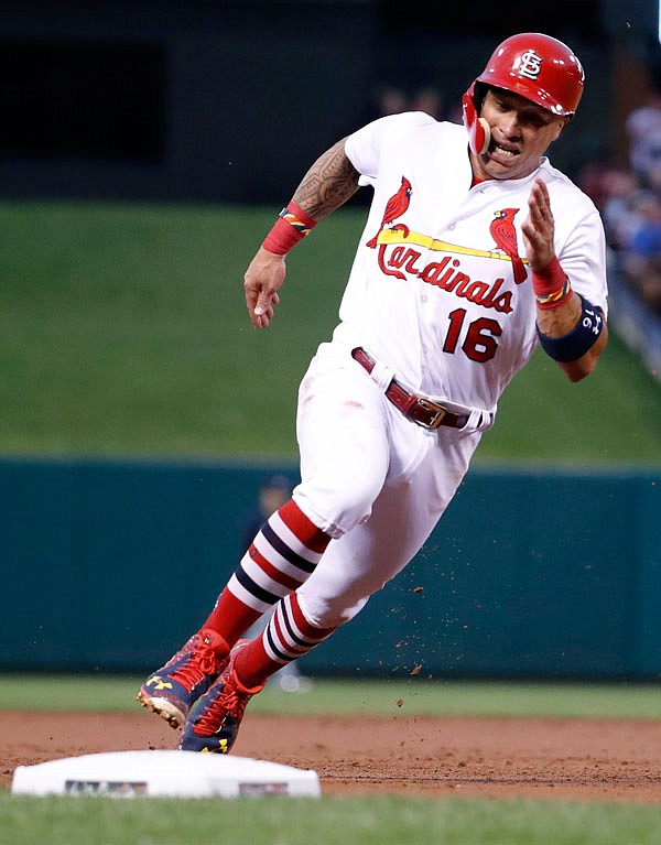 Kolten Wong of the Cardinals rounds third and heads home to score on a single by Randal Grichuk during the second inning of Friday night's game against the Braves at Busch Stadium in St. Louis.