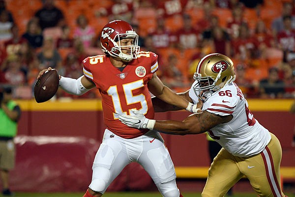 Chiefs quarterback Patrick Mahomes is pursued by 49ers defensive lineman Noble Nwachukwu  during the second half of Friday night's preseason game at Arrowhead Stadium in Kansas City.