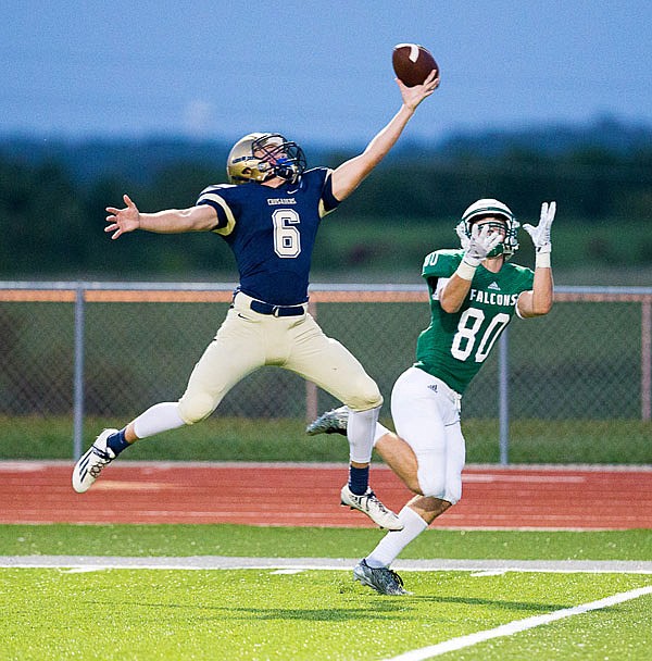 Zach Woehr of Helias tries to break up a pass intended for Ben Thomas of Blair Oaks during Friday night's Jamboree at the Falcon Athletic Complex in Wardsville.  