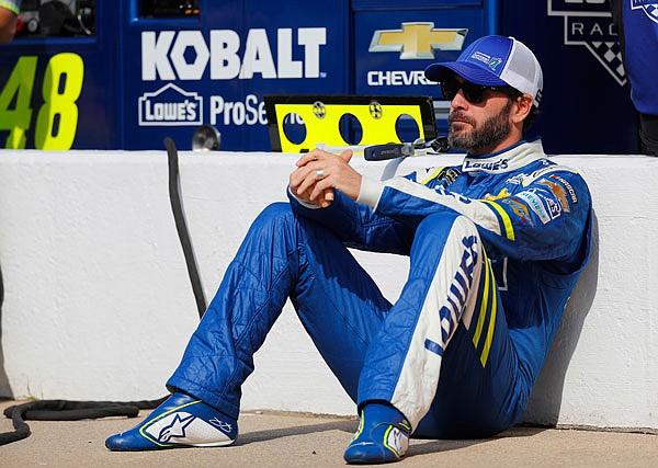 Jimmie Johnson sits in the pits prior to Friday's qualifying session for the NASCAR Cup Series race in Brooklyn, Mich.