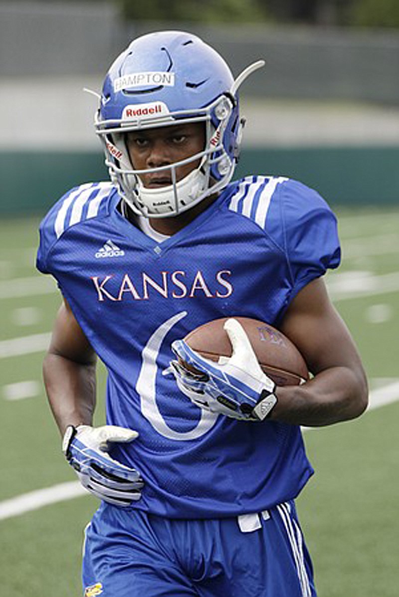 Kansas freshman receiver Quan Hampton secures a pass during a preseason practice on Aug. 7.