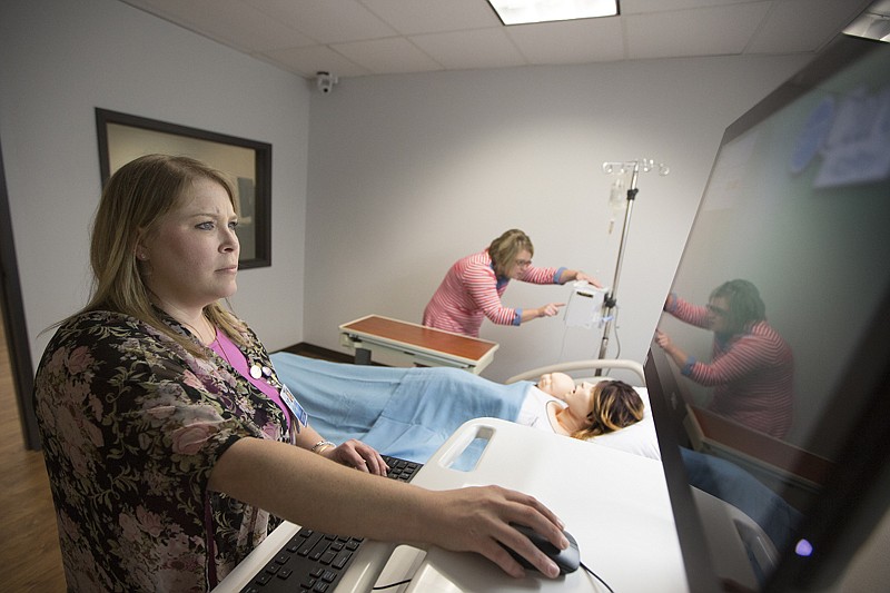 Texarkana College instructors Lauren Jamison, RN/MSN, and Leslie Banister, RN/MSN, set up the SimMom birthing simulator Friday in the new sim lab. The nursing program received a $304,006 grant from the Texas Workforce Commission. The majority of the money was used to purchase equipment, including the SimMom, which cost more than $60,000. TC now has an array of simulators to be used in the nursing and pharmacy tech programs. 