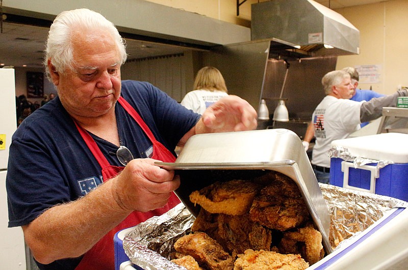 Richard Barnard dumps a fresh batch of fried chicken into a cooler Saturday, Aug. 12, 2017 to be
served during the Talon Leach benefit dinner at the American Legion Post 5. Within
the first hour and a half, of the four-hour event more than $1,000 was raised. Inset:
Patriotic material is put on display for the silent auction, which raised money for
Leach's family.