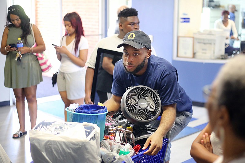 Lorenzo Beach, center, helps move freshmen into Dawson Hall on Saturday, Aug. 12, 2017 at Lincoln University in Jefferson City. Beach was elected Mr. Lincoln University 2017 and was on hand to help welcome new students.