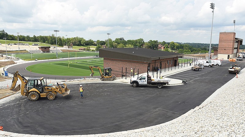 Construction of Helias' new stadium and support infrastructure is nearly complete as the high school prepares to start classes next week. Electricians were running wire for lighting Friday, Aug. 11, 2017 while fence installers worked to enclose the buildings. Across the street from the athletic complex, concrete was being poured to form the outer edge of the parking lot that was torn out in order to construct the tunnel that connects the school grounds to the stadium.