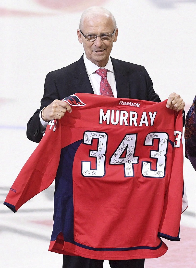 Bryan Murray, senior hockey adviser to the Ottawa Senators, holds a signed Washington Capitals jersey on Jan. 24 as he is inducted as the first member of the Ottawa Senators' new "ring of honor" in Ottawa, Canada.