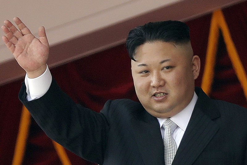 FILE - In this April 15, 2017, file photo, North Korean leader Kim Jong Un waves during a military parade in Pyongyang, North Korea. North Korea said Tuesday, Aug. 15, 2017 that leader Kim Jong Un was briefed on his military's plans to launch missiles into waters near Guam as part of an effort to create "enveloping fire" near the U.S. military hub in the Pacific. (AP Photo/Wong Maye-E, File)