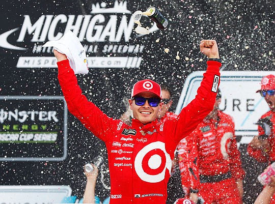 Kyle Larson celebrates winning the NASCAR Cup Series race Sunday in Brooklyn, Mich.