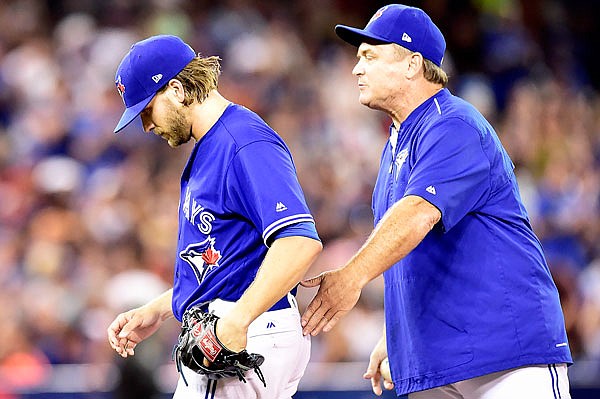 Blue Jays manager John Gibbons gives his encouragement as he pulls starting pitcher Chris Rowley from the game during the sixth inning Saturday in Toronto. Rowley, the first graduate of West Point to reach the major leagues, got the win as the Blue Jays defeated the Pirates 7-1.