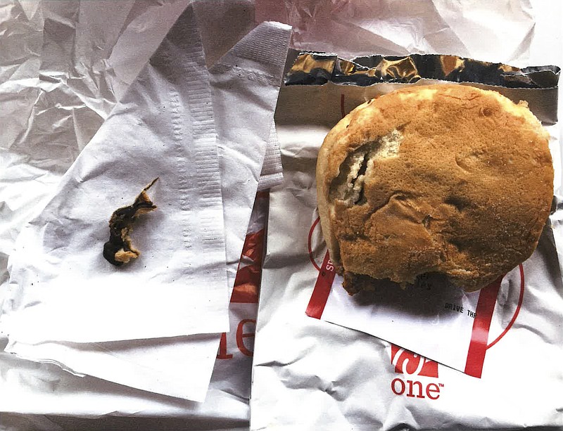 This Nov. 25, 2016, photo provided by Ellen Manfalouti, of Holland, Pa., shows the remains of a rodent, left, she alleges she found baked into the bun of a chicken sandwich, right, that a co-worker purchased for her that day at a Chick-fil-A franchise restaurant in Langhorne, Pa. Manfalouti, a suburban Philadelphia woman, sued in Bucks County Court in August 2017 over the rodent she claims was baked into the bottom bun of her chicken sandwich. (Ellen Manfalouti via AP)