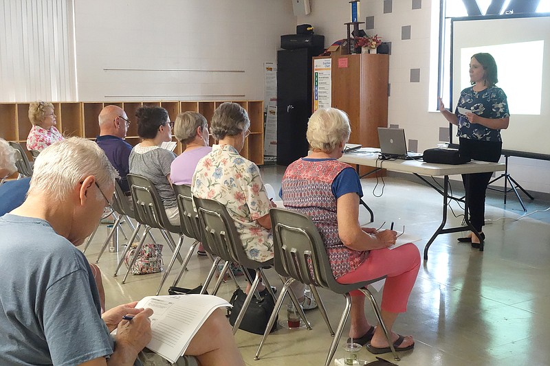 Amanda de la Mater, program and education specialist at Alzheimer's Association, presents the first part of a health series called "Early Detection: Know the Signs" at Knowles YMCA.