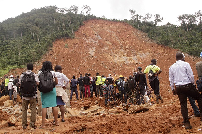 Volunteers wait at the scene of heavy flooding and mudslides in Regent, just outside of Sierra Leone's capital Freetown, Tuesday, Aug. 15 , 2017. Survivors of deadly mudslides in Sierra Leone's capital are vividly describing the disaster as President Ernest Bai Koroma says the nation is in a "state of grief." (AP Photo/ Kabba Kargbo)
