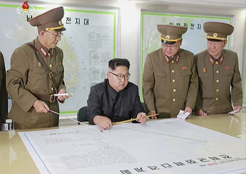 This image made from video of an Aug. 14, 2017, still image broadcast in a news bulletin on Tuesday, Aug. 15, 2017, by North Korea's KRT shows North Korean leader Kim Jong Un receiving a briefing in Pyongyang. North Korea said leader Kim Jong Un was briefed on his military's plans to launch missiles in waters near Guam days after the Korean People's Army announced its preparing to create "enveloping fire" near the U.S. military hub in the Pacific. Independent journalists were not given access to cover the event depicted in this photo. (KRT via AP Video)