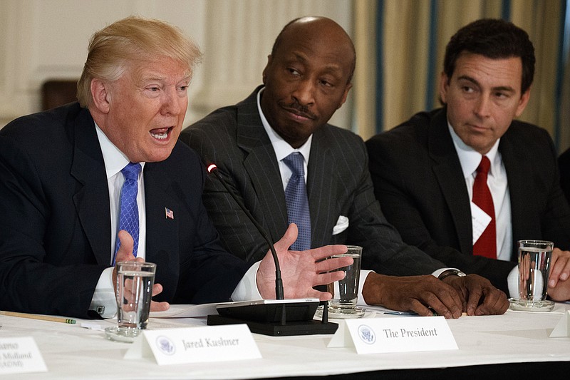 FILE - In this Thursday, Feb. 23, 2017, file photo, President Donald Trump, left, speaks during a meeting with manufacturing executives at the White House in Washington, including Merck CEO Kenneth Frazier, center, and Ford CEO Mark Fields. Frazier is resigning from the President’s American Manufacturing Council citing "a responsibility to take a stand against intolerance and extremism." Frazier's resignation comes shortly after a violent confrontation between white supremacists and protesters in Charlottesville, Va. Trump is being criticized for not explicitly condemning the white nationalists who marched in Charlottesville. (AP Photo/Evan Vucci, File)