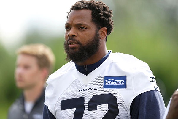 In this June 13 file photo, Seahawks defensive end Michael Bennett walks off the field following practice in Renton, Wash.