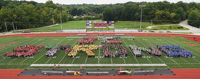 Jefferson City Public Schools hosted a back-to-school pep rally for faculty and staff in Fleming Fieldhouse followed by a trip to Adkins Stadium behind the marching band drum line. Once on the field, they filled in an outiline of of the letters J-C S-T-R-O-N-G for the district group photograph.