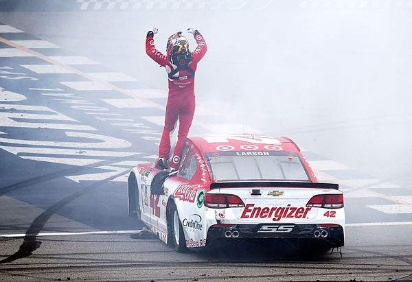 Kyle Larson celebrates winning Sunday's NASCAR Cup Series race in Brooklyn, Mich.