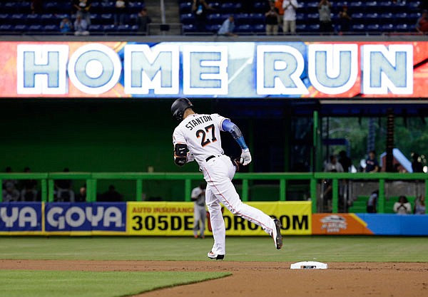 Marlins outfielder Giancarlo Stanton runs the bases after hitting a two-run home run during the first inning of Monday night's game against the Giants in Miami.