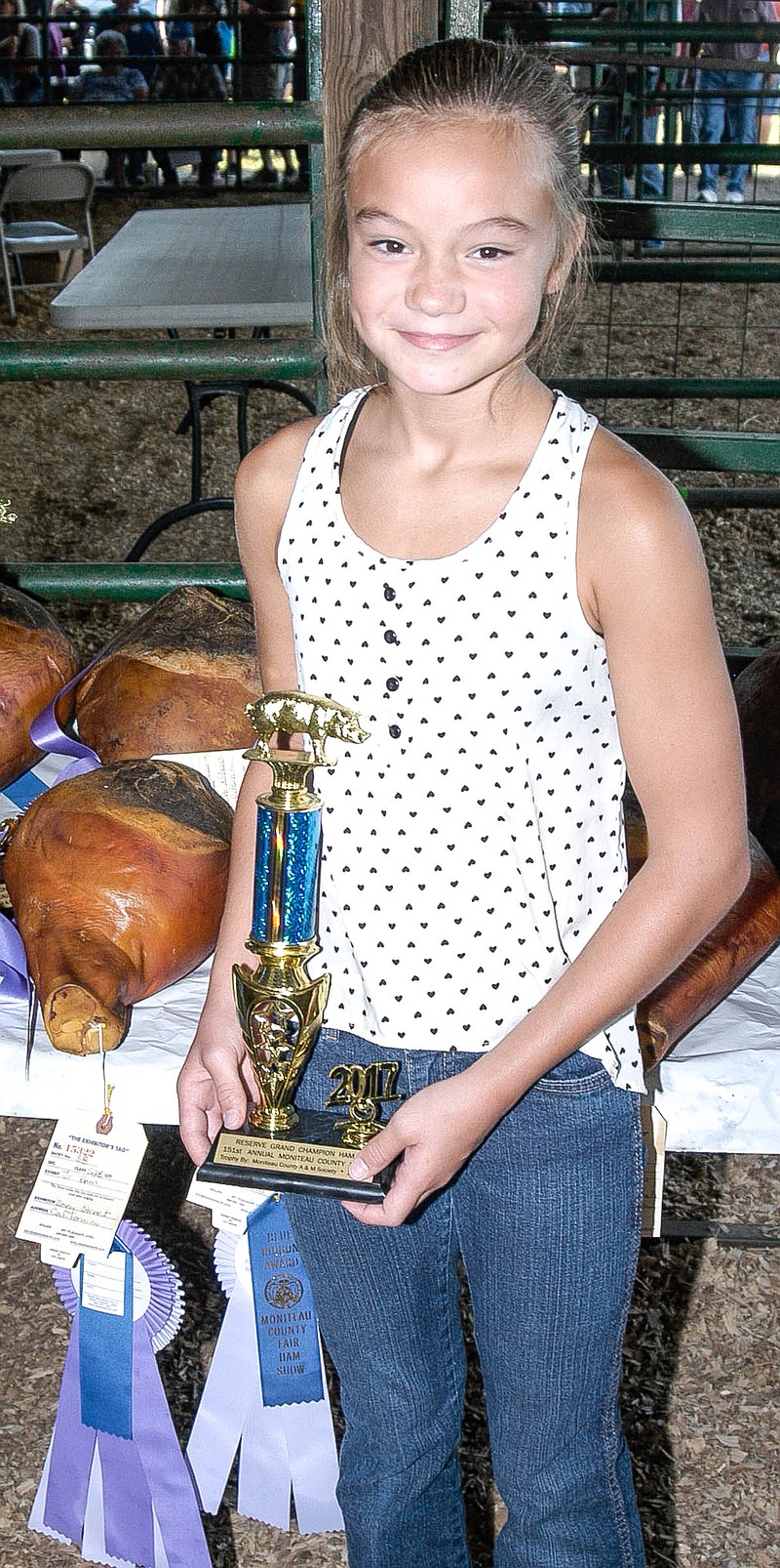 Zoey Street with the grand champion junior ham at the Moniteau County Fair Junior Ham Auction Aug. 12. She is a member of Twin City 4-H Club.