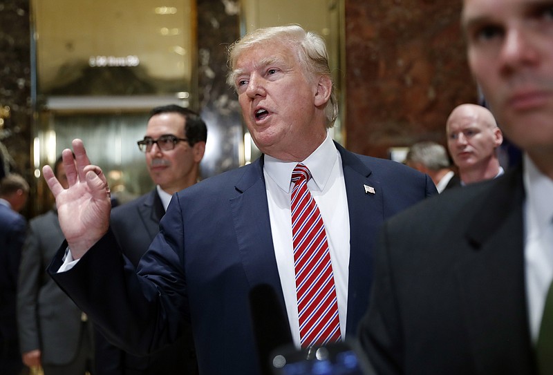 President Donald Trump gestures as he answers reporters questions in the lobby of Trump Tower, Tuesday, Aug. 15, 2017 in New York.