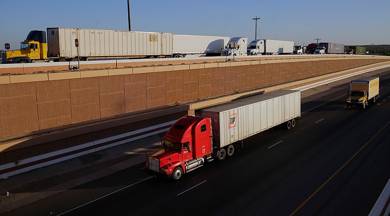 In this Monday, Nov. 21, 2016, file photo, trucks move along Interstate 35, in Laredo, Texas. U.S. President Donald Trump's campaign promise to abandon the North American Free Trade Agreement helped win over Rust Belt voters who felt left behind by globalization. But the idea is unnerving to many people in cities on the U.S.-Mexico border, like Laredo. Five days of talks aimed at overhauling NAFTA begin Wednesday, Aug. 16, 2017, in Washington, with negotiations to follow in Mexico and Canada.