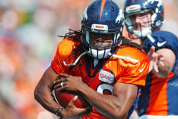 Broncos running back Jamaal Charles runs with a handoff from quarterback Paxton Lynch during drills last month at training camp in Englewood, Colo.