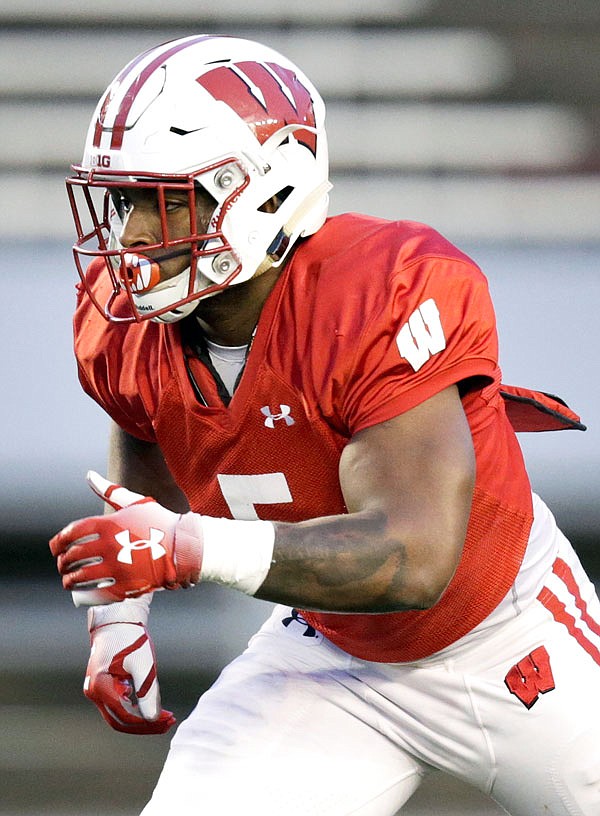 In this April 21 file photo, Wisconsin running back Chris James prepares to take a handoff during a spring game in Madison, Wis.