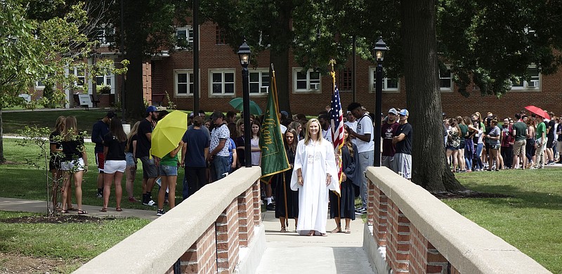 Baylie Borman, senior class president at William Woods University, prepares to lead a line of new WWU students across the Senior Lake bridge in the school's traditional ivy ceremony. Students also attended a convocation ceremony during which professor Travis Tamerius told them not to worry about their parents. "Your parents will be OK, I promise. It's quite possible they'll move to a beach house somewhere," he said sarcastically.