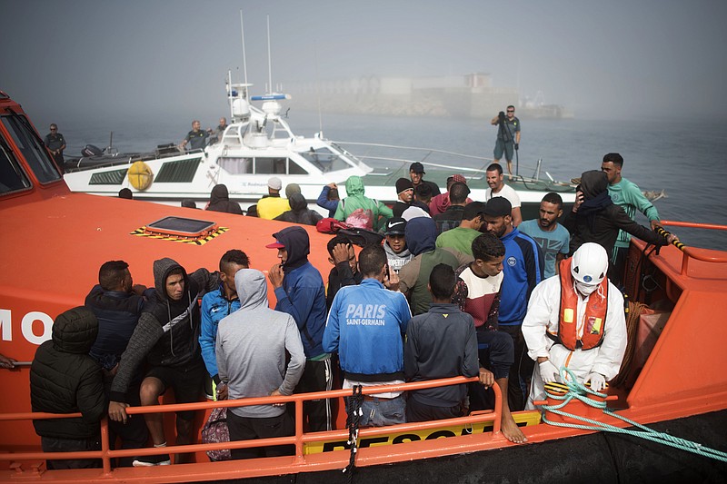 EDS NOTE : SPANISH LAW REQUIRES THAT THE FACES OF MINORS ARE MASKED IN PUBLICATIONS WITHIN SPAIN - Migrants arrive on board a Spain's maritime rescue boat at the port of Tarifa, southern Spain, after being rescued in the Strait of Gibraltar, Wednesday, Aug. 16, 2017. Spain's maritime rescue service has saved more than 600 migrants trying to cross the Mediterranean Sea from Morocco in the past 24 hours, making it one of its busiest days so far this year. (AP Photo/ Marcos Moreno)